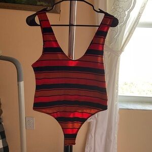 Woman’s colorful bodysuit.